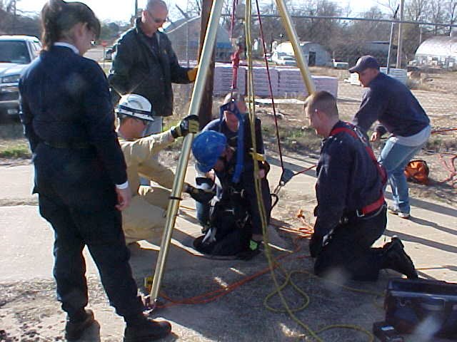 Fire Department personnel training to go down a manhole.